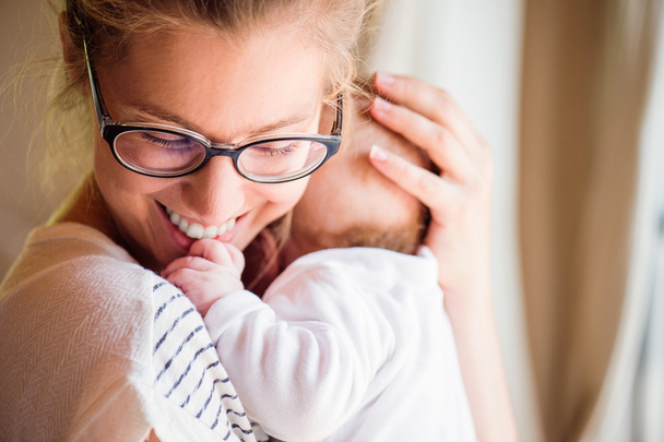 Close up of beautiful mother holding her baby son - Valokuva, kuva