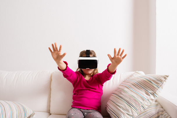 Girl wearing virtual reality goggles. Studio shot, copy space - Foto, immagini