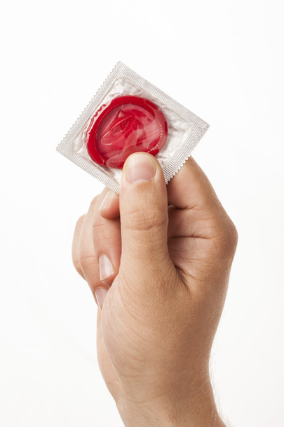 Hand with condom - Foto, Imagen