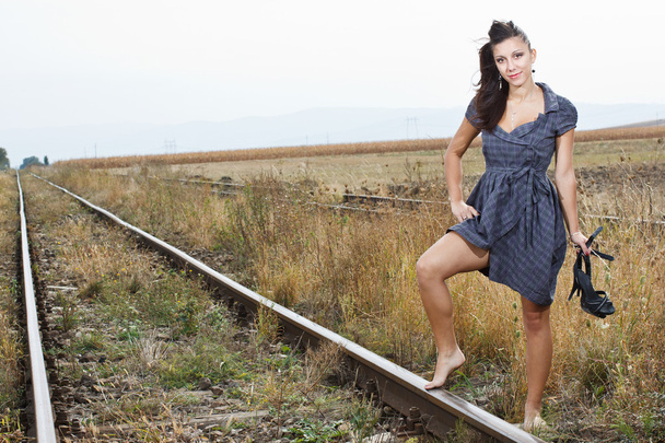 Beautiful young woman on the railroad - Photo, Image