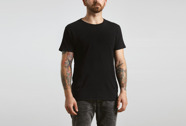 man poses in black blank t-shirt - Fotó, kép