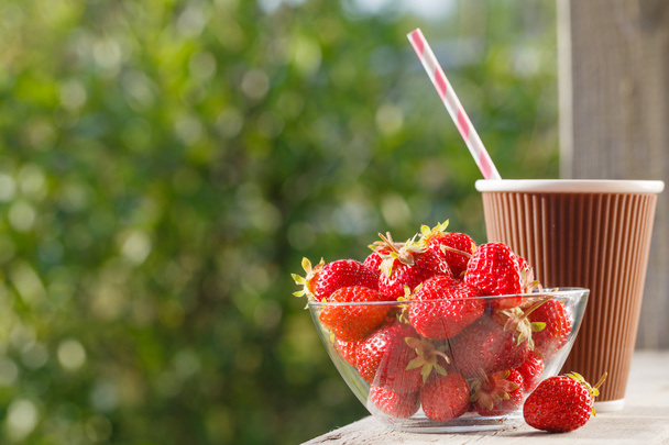 Strawberries in a bowl, natural background, outside - Valokuva, kuva