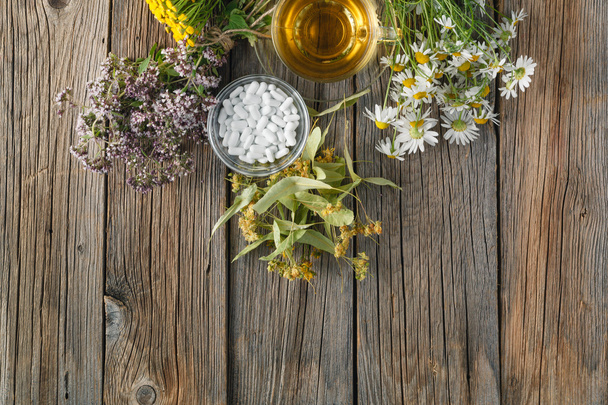 Ancient herbal medicine on wooden background - Fotó, kép