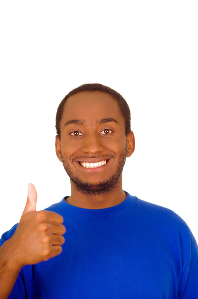 Headshot handsome man wearing strong blue colored t-shirt and giving thumb up smiling to camera - Foto, imagen