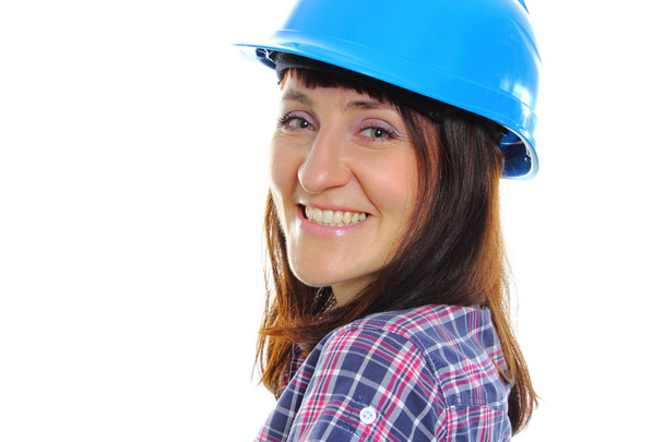 Smiling builder woman wearing protective blue helmet - 写真・画像