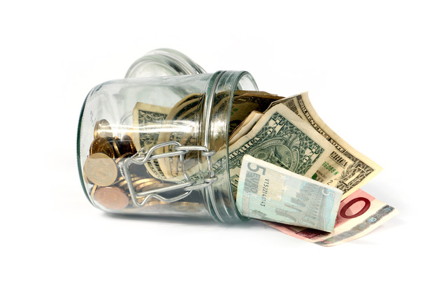 glass jar with small change - Foto, imagen