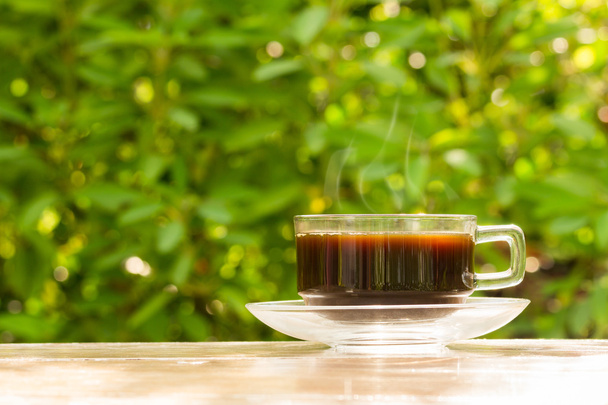 Glass cup of black coffee on wooden table  - Foto, imagen
