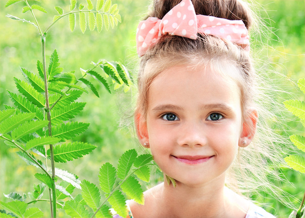 Adorable smiling little girl on the meadow in summer day - Photo, image