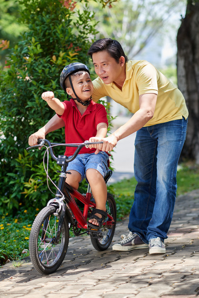 Father learning cycling his child - Photo, Image