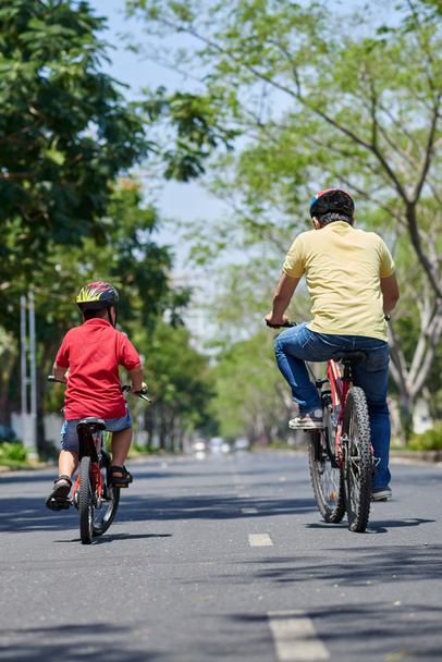 father and son enjoying cycling - Photo, Image
