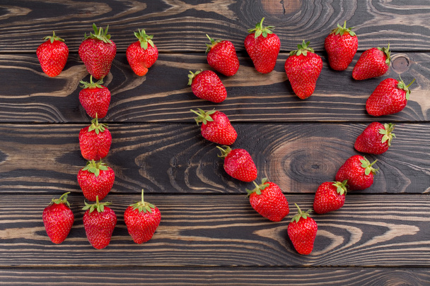 words i love you lettered with fresh organic strawberry. - Foto, Imagen