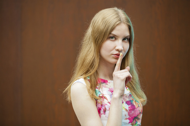 Young beautiful blonde woman has put forefinger to lips as sign  - Foto, immagini