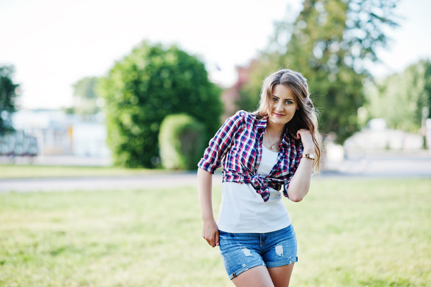 Portrait of style country girl on short jeans shorts and crossco - Fotó, kép