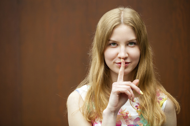 Young beautiful blonde woman has put forefinger to lips as sign  - Foto, Imagem
