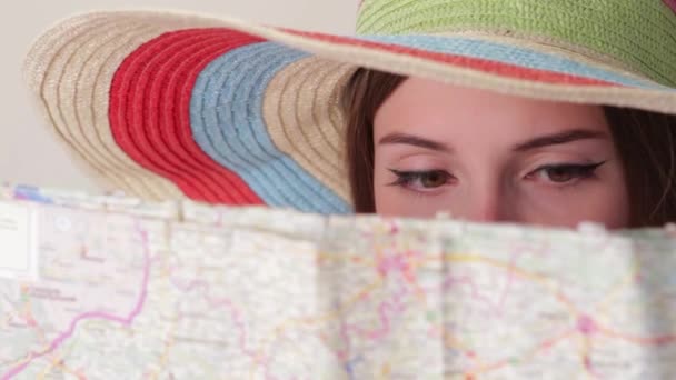 Girls face behind a map. - Footage, Video
