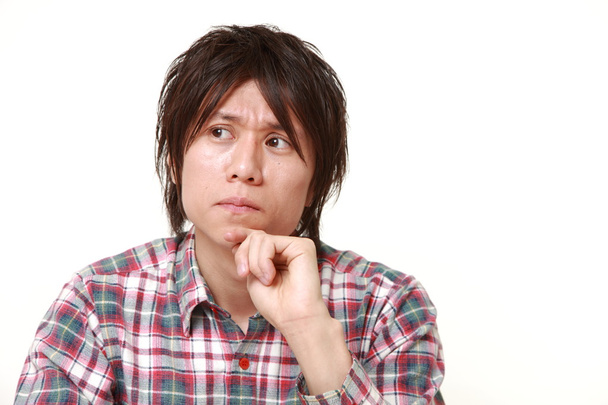 young Japanese man worries about something - Foto, Bild