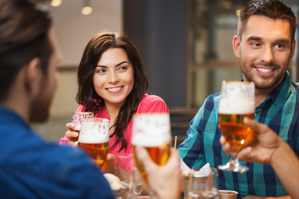 friends dining and drinking beer at restaurant - Fotoğraf, Görsel