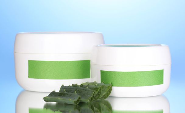 Jars of cream with aloe vera on blue background - Zdjęcie, obraz