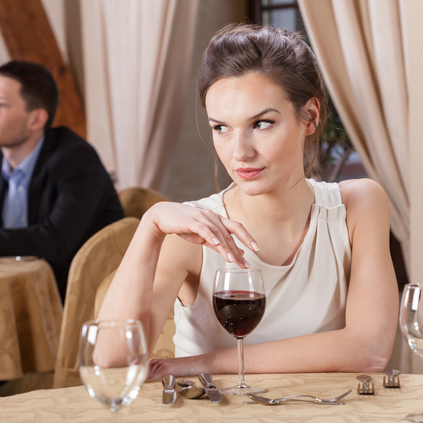 Woman drinking wine in a restaurant - 写真・画像