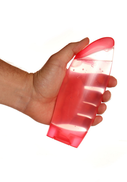 Hand holding pink shower gel  - Valokuva, kuva