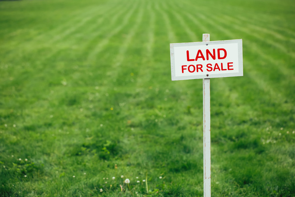 Grundstücke zum Verkauf Schild gegen Rasenschnitt Hintergrund - Foto, Bild