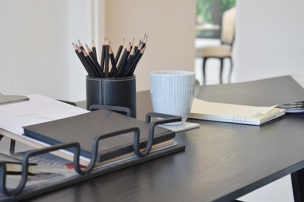 work table with book,pencils, cup of coffee and clock in a home - Foto, immagini