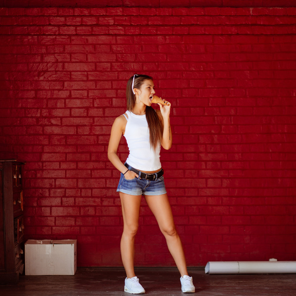 Young sexy girl eating ice cream in summer hot weather. Have fun and good mood - Foto, imagen