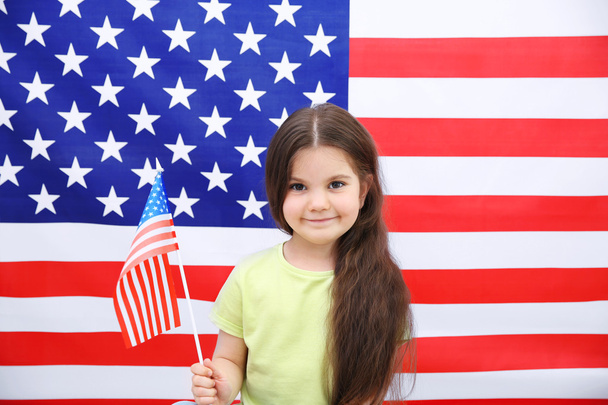 Cute little girl on American flag background - Photo, Image