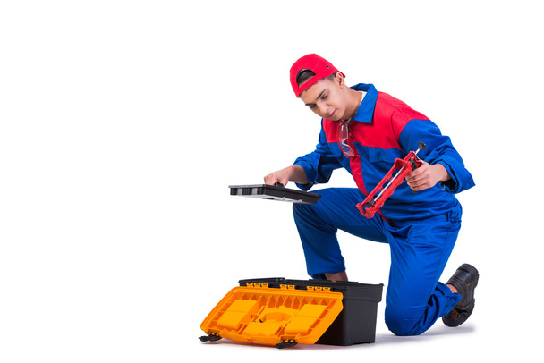 Young repairman with silicone gun isolated on white - Φωτογραφία, εικόνα