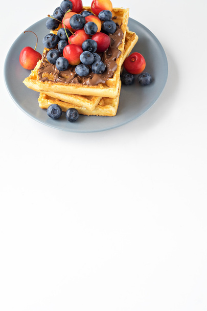 Plate of belgian waffles with chocolate and berries - Photo, Image