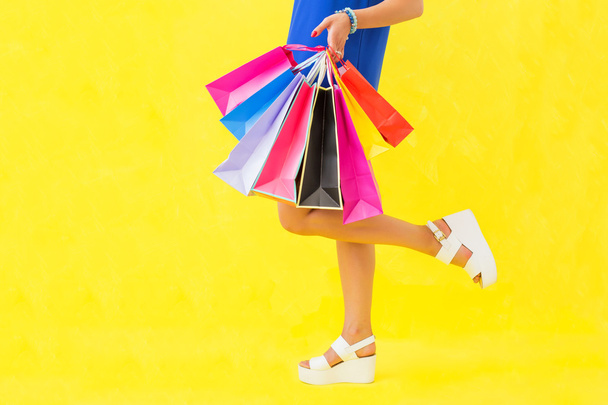 Woman with shopping bags in one hand - Photo, Image