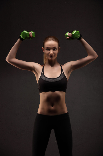 Athletic young woman doing a fitness workout with weights. Fitness girl - Foto, Imagen