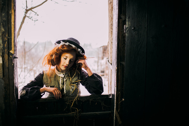 Red haired girl in a barn - Фото, изображение