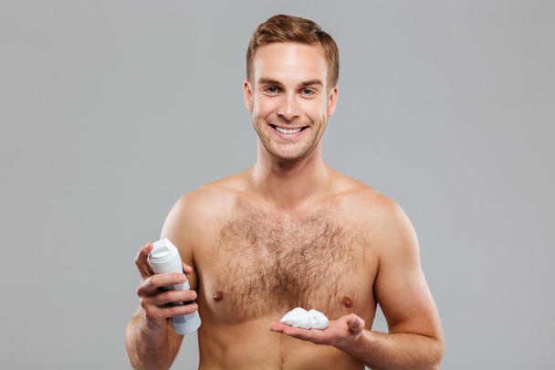 Sexy handsome young man with a shaving foam - Photo, image