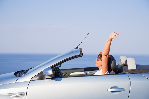 Young woman drive a car on the beach. - Photo, Image