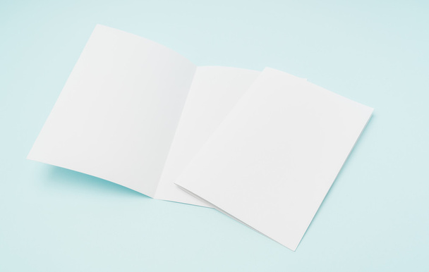 Bifold white template paper on blue background . - Fotó, kép