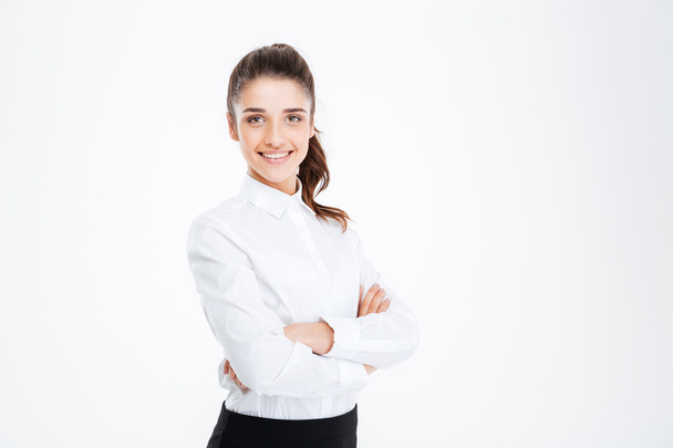 Portrait of a smiling businesswoman standing with arms folded - Photo, Image