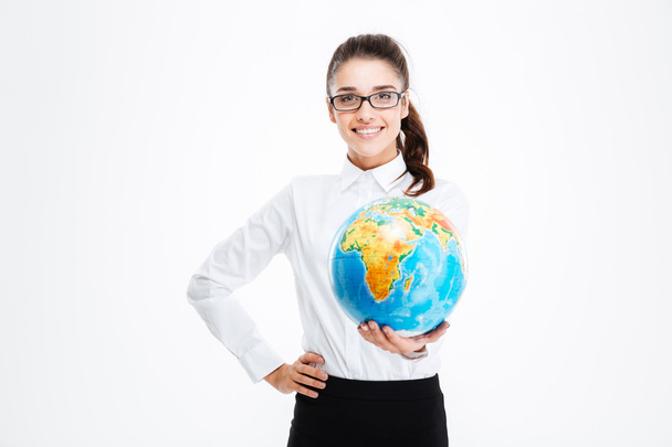 Cheerful pretty young businesswoman smiling and holding globe - Foto, immagini