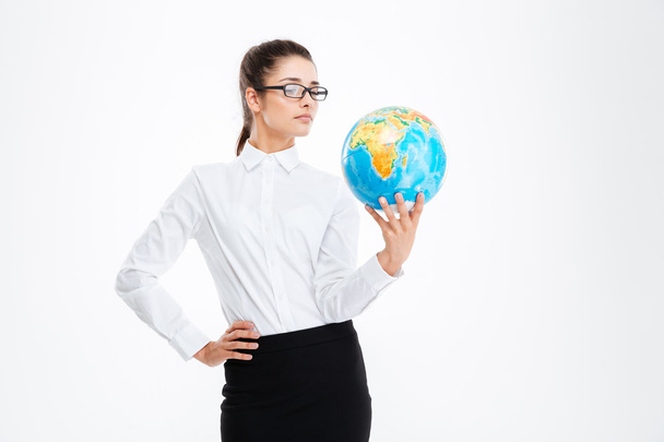 Pensive attractive young business woman holding earth globe - Фото, изображение