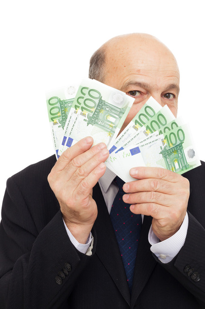 starší muž skrývá vedle peníze - Fotografie, Obrázek