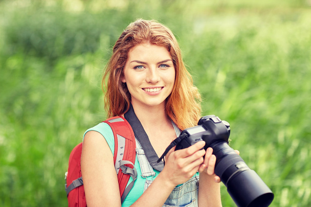 happy woman with backpack and camera outdoors - Fotoğraf, Görsel