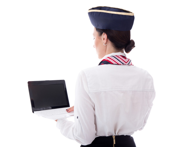 back view of young stewardess showing laptop with blank screen i - Foto, afbeelding