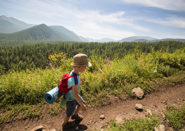 boy running by mountains track - Photo, Image