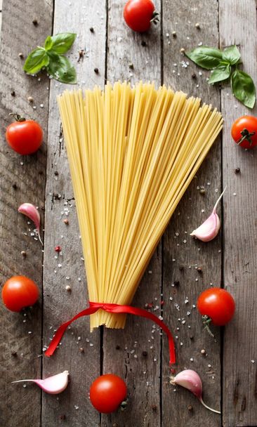 Ingredients for cooking pasta with tomato, black pasta, herbs, spices. - Photo, Image