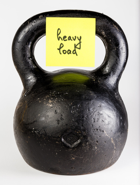 Black kettlebell with label heavy load  - Photo, Image
