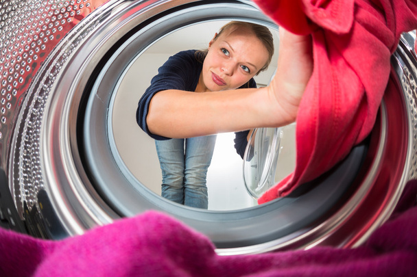 Housework: young woman doing laundry (shallow DOF; color toned i - Foto, Imagen