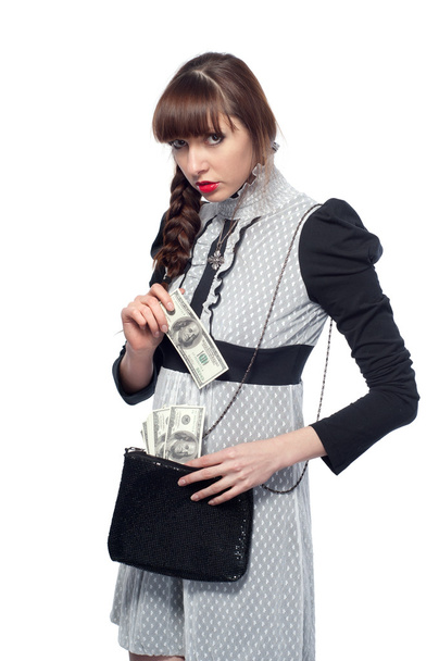 Молодая девушка вытаскивает доллары из сумки. На белом фоне
 - Фото, изображение