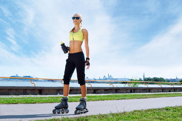 Young and fit woman rollerblading on skates - Фото, изображение