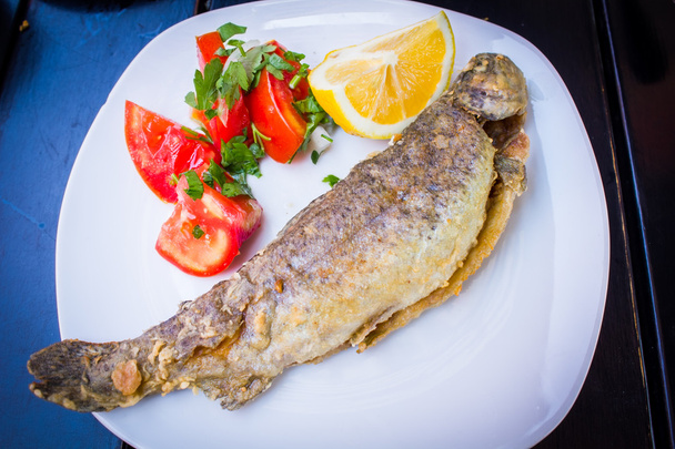 fried fish with fresh herbs and lemon - Photo, Image