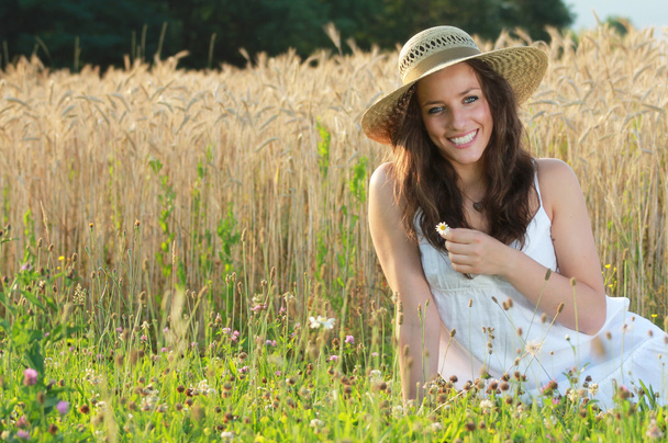 Young and happy girl with an hay hat - Foto, Imagen
